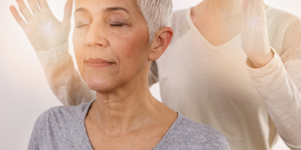 Woman receiving gentle supportive energy work during a spiritual coaching session