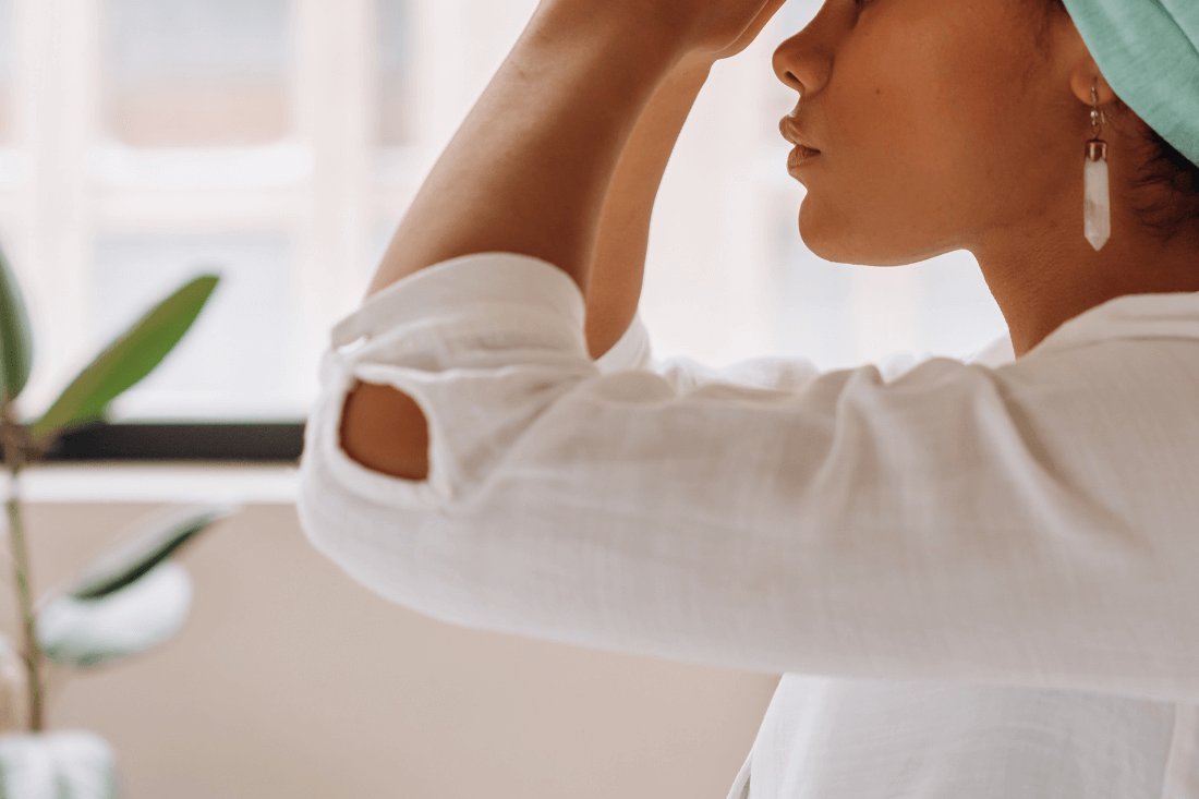 Woman practicing Reiki in a calm indoor setting during spiritual healing training