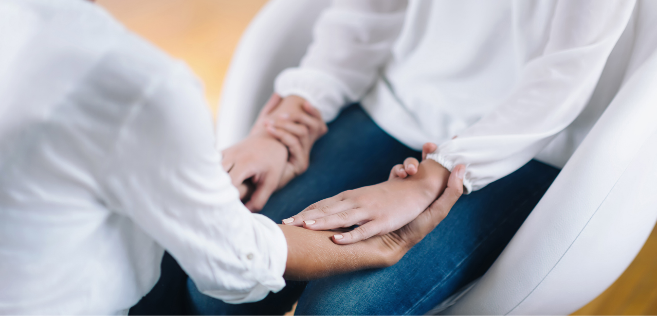 Hands offering Reiki healing over a client during a session